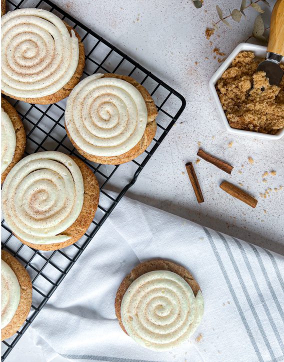 The Best Soft Snickerdoodle Frosted Cake Cookies on a cooling tray