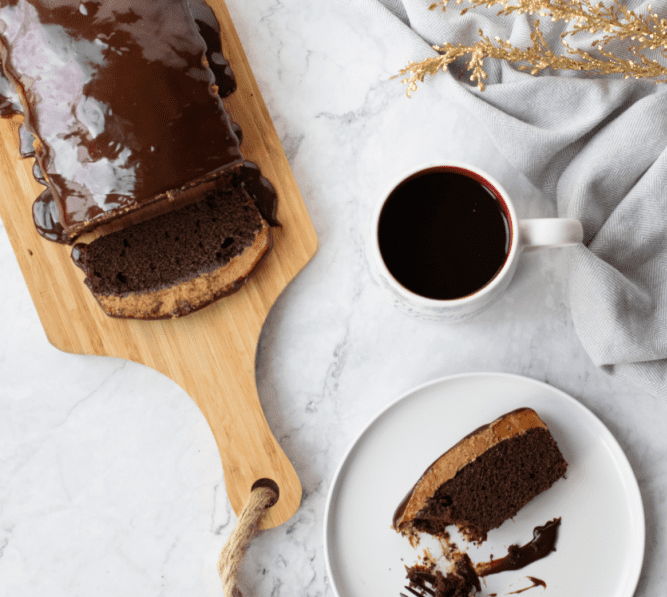 Chocolate Coffee Loaf Cake in a wooden bread chopping board.