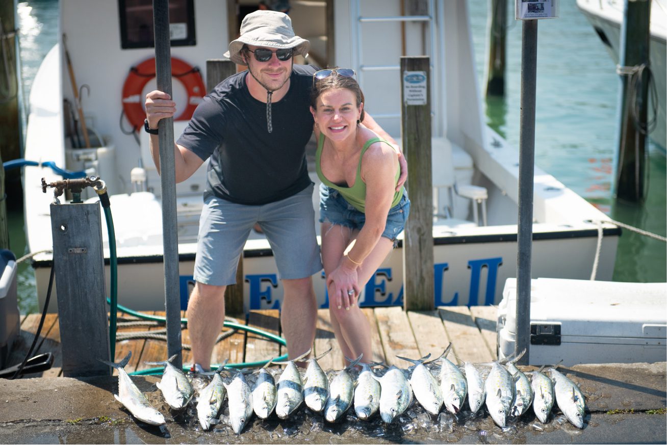 Casey and her husband with a lot of fish caught