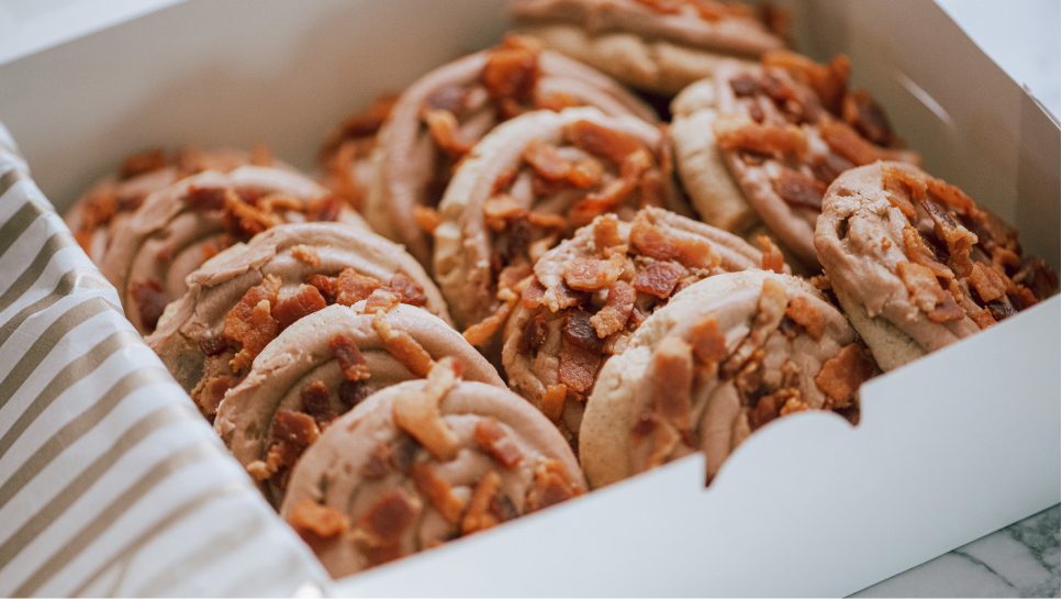 A set of soft Maple Bacon cookies in a box